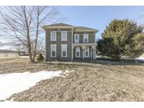 Two-story farmhouse with a large front yard at 1112 N Five Points Rd, Greenwood, IN 46143