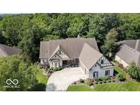 Stunning two-story home with an expansive driveway, lush landscaping, and impeccable exterior finishes at 14565 Geist Ridge Dr, Fishers, IN 46040