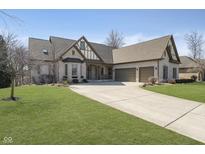 Charming home with a spacious three-car garage and well-manicured lawn at 14565 Geist Ridge Dr, Fishers, IN 46040