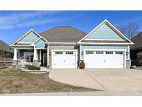 Two-story craftsman style home with a large front porch and three-car garage at 1574 Leisure Way, Greenfield, IN 46140