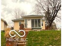 Charming home featuring a cute front porch and a brick step approach nestled in a well-treed yard at 252 Ringwood Way, Anderson, IN 46013