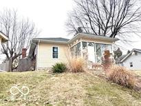 House exterior with a sunroom and sloped lawn at 252 Ringwood Way, Anderson, IN 46013
