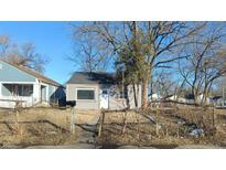 Gray vinyl-sided house with a small front yard and wooden fence at 2925 Stuart St, Indianapolis, IN 46218