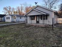 Picture of the house with a porch and well kept yard. Perfect for families or individuals at 3619 N Hawthorne Ln, Indianapolis, IN 46218