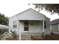 Charming home featuring a covered front porch, vinyl siding, and well-kept landscaping at 3954 Fletcher Ave, Indianapolis, IN 46203