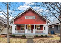 Charming red home with white trim, inviting porch, and well-maintained landscaping at 4616 Carrollton Ave, Indianapolis, IN 46205