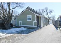 Charming light green house with a driveway and small yard at 5021 W Minnesota St, Indianapolis, IN 46241