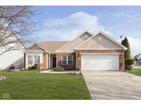 Brick ranch home with a two-car garage and well-maintained lawn at 5437 Basin Park Dr, Indianapolis, IN 46239