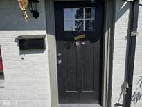 Charming front door with a welcoming bicycle decor, set against a white brick facade at 6508 Meadowlark Dr, Indianapolis, IN 46226