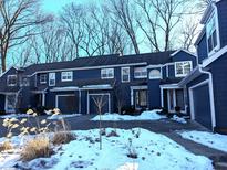 Front view of a charming blue two-story home with attached garage at 7841 Harbour # 35, Indianapolis, IN 46240