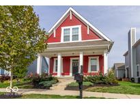 Charming red two-story home with white columns and landscaping at 10854 Descanso Dr, Fishers, IN 46038