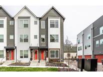 Three-story townhouses with modern gray and white siding, red doors, and landscaping at 1738 Alloy Dr, Indianapolis, IN 46201