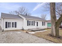 White house with gray roof, black shutters, and small front porch at 1749 Sparrow Ave, Indianapolis, IN 46227