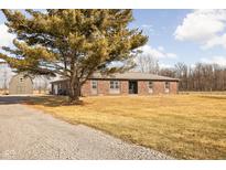 Ranch home with brick exterior, attached garage, and expansive yard at 1926 Commerce Way, Pittsboro, IN 46167