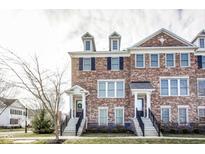 Charming brick townhomes with symmetrical design, dormer windows, and inviting front entrances at 2009 Broughton St, Carmel, IN 46032