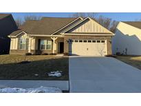 Brick ranch home with a two-car garage and landscaped lawn at 2746 Lanai Ln, Greenwood, IN 46143