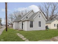 Charming home featuring gray siding, a well-maintained lawn, and a classic architectural design at 3102 N Arsenal Ave, Indianapolis, IN 46218