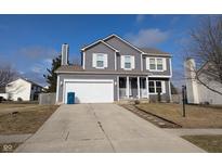 Gray two-story house with white garage door and landscaping at 3448 Waterloo Dr, Indianapolis, IN 46268