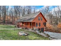Charming two-story home with a cozy front porch, complemented by the natural surroundings at 4104 W Fox Trl, Trafalgar, IN 46181