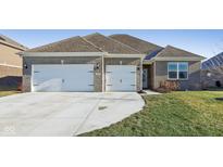 Brick house with a two-car garage and well-maintained lawn at 4540 W Tradwell Dr, New Palestine, IN 46163