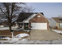 Brick ranch home with attached garage and front porch at 6420 Birds Eye Dr, Indianapolis, IN 46203