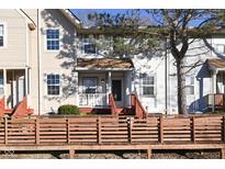 Tan two-story townhome with a wooden deck and small front yard at 6639 N College Ave, Indianapolis, IN 46220