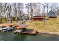 Waterfront homes with private docks along a picturesque lakefront community in a serene, wooded setting at 7423 Grizzly Dr, Nineveh, IN 46164
