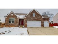 Brick ranch home with two-car garage and snow-covered lawn at 7591 Basswood Dr, Avon, IN 46123