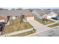 Brick ranch home with attached garage and driveway, nicely landscaped front yard at 7842 Cork Bend Ln, Indianapolis, IN 46239