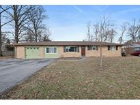 Brick ranch house with attached garage and landscaped yard at 816 E Elbert St, Indianapolis, IN 46227