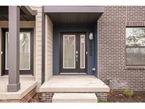Modern townhome exterior with brick and siding, featuring a covered entryway at 9893 Greenvine Dr, Carmel, IN 46032