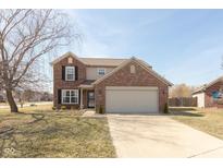 Charming two-story home with brick facade and attached two-car garage, landscaped with green bushes at 1062 Amy Ct, Greenwood, IN 46143