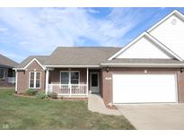 Charming single-Gathering home with brick exterior, covered porch, two-car garage, well-manicured lawn, and blue sky at 11835 Civic Cir, Mooresville, IN 46158