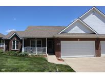 Charming brick home featuring an attached garage, a covered front porch, and well-maintained landscaping at 11835 Civic Cir, Mooresville, IN 46158