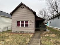 Beige house with a small front porch and yard at 1456 Hoyt Ave, Indianapolis, IN 46203