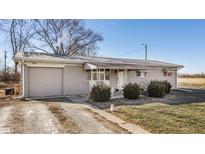 Charming single story home with a stone facade and an attached one-car garage, complemented by a well-maintained front yard at 1505 E 1000 N, Pendleton, IN 46064