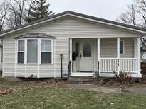 Beige house with white porch and bay window at 2413 N Milton St, Muncie, IN 47303