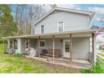 Charming two-story home featuring a covered porch with seating, perfect for enjoying the outdoors at 310 Green St, Plainfield, IN 46168