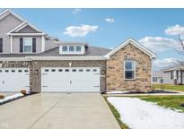 Two-story home with stone and brick accents, two-car garage, and a landscaped front yard at 6433 Wasco Dr, Whitestown, IN 46075