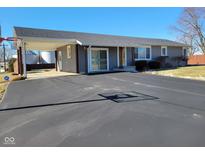 Gray house with carport, long driveway, and basketball hoop at 9790 Nw Union Rd, Mooresville, IN 46158