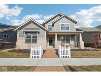 Charming two-story home with a welcoming front porch and landscaped yard at 1290 Chatham Hills Blvd, Westfield, IN 46074