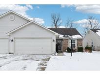 Charming single-story home featuring a two-car garage and a snow-covered front yard at 1305 Long Shore Dr, Indianapolis, IN 46217