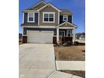 Charming two-story home features a two-car garage, blue siding, and a welcoming front porch at 2322 Dixon Creek Dr, Whitestown, IN 46075