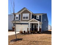 Charming two-story home with a covered porch, attached garage, and well-maintained lawn at 2322 Dixon Creek Dr, Whitestown, IN 46075