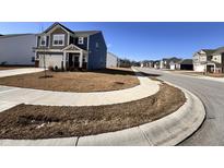 A quiet street view showcases a neighborhood with well-kept lawns and sidewalks at 2322 Dixon Creek Dr, Whitestown, IN 46075