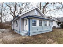 Newly renovated home with gray siding, blue accents and a landscaped yard at 3340 N Sherman Dr, Indianapolis, IN 46218