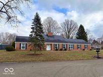 Brick ranch house with a large front yard and mature trees at 3618 N Royal Oak Dr, Muncie, IN 47304