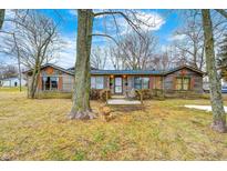Ranch style home with wood siding and a spacious yard at 3818 Fayette Dr, Brownsburg, IN 46112