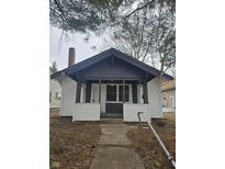 Charming bungalow with black and white exterior, front porch, and well-maintained landscaping at 4041 Boulevard Pl, Indianapolis, IN 46208