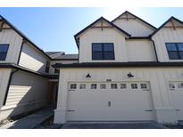 Charming townhome featuring a pristine, panelled garage door and stylish black accents at 4195 Douro Trl, Westfield, IN 46062